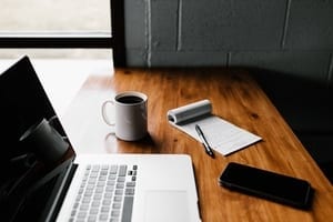 Desk with notebook and laptop